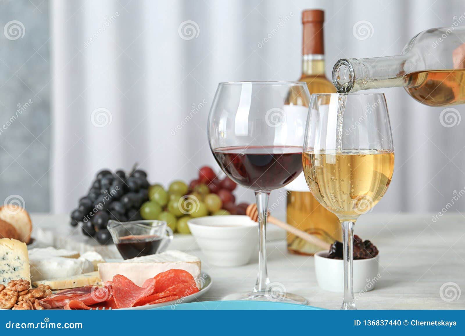 Pouring White Wine into Glass on Served Table. Stock Photo Image of