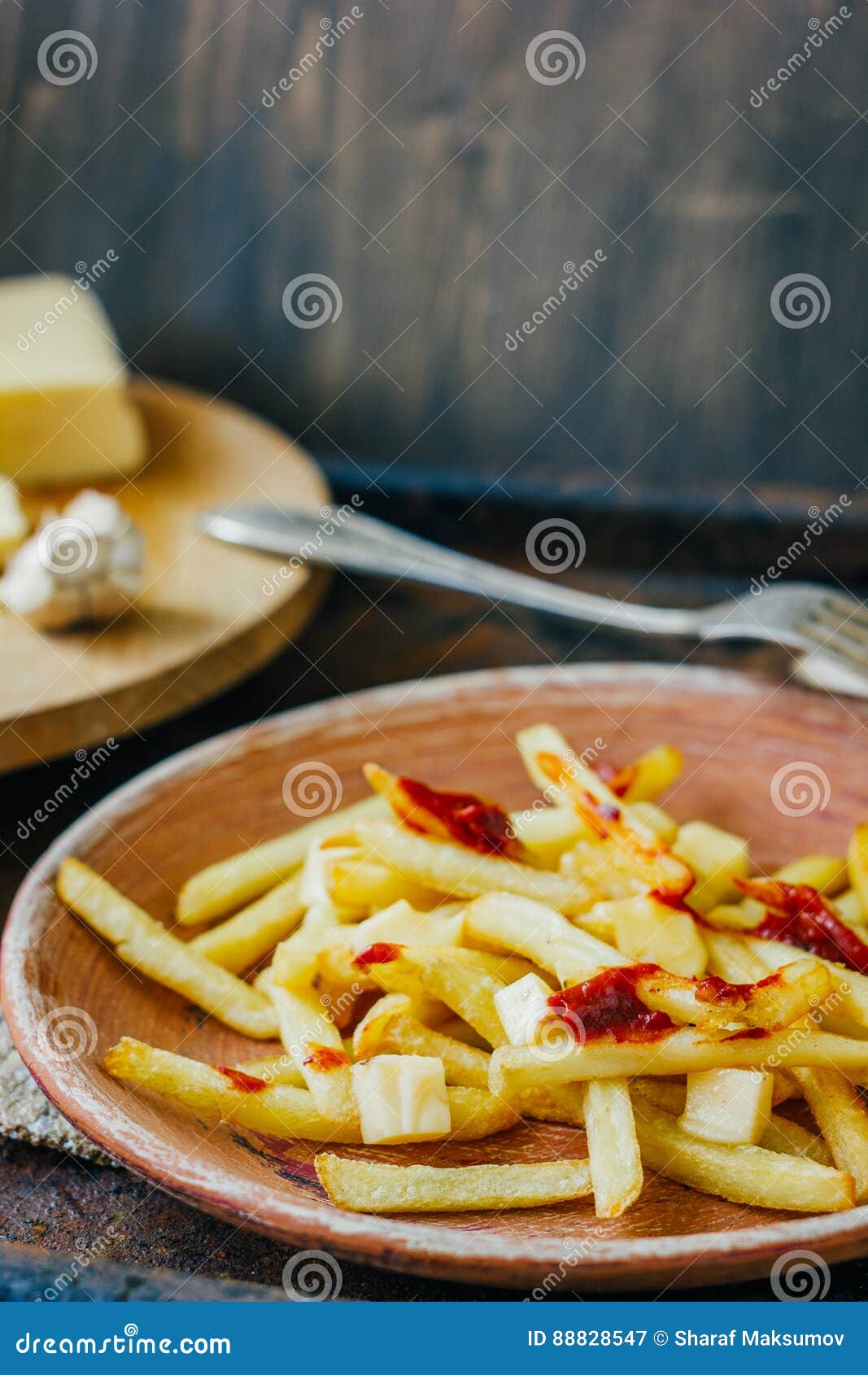 Poutine Fries on Black Surface. Canadian Dish with Potatoes, Cheese and