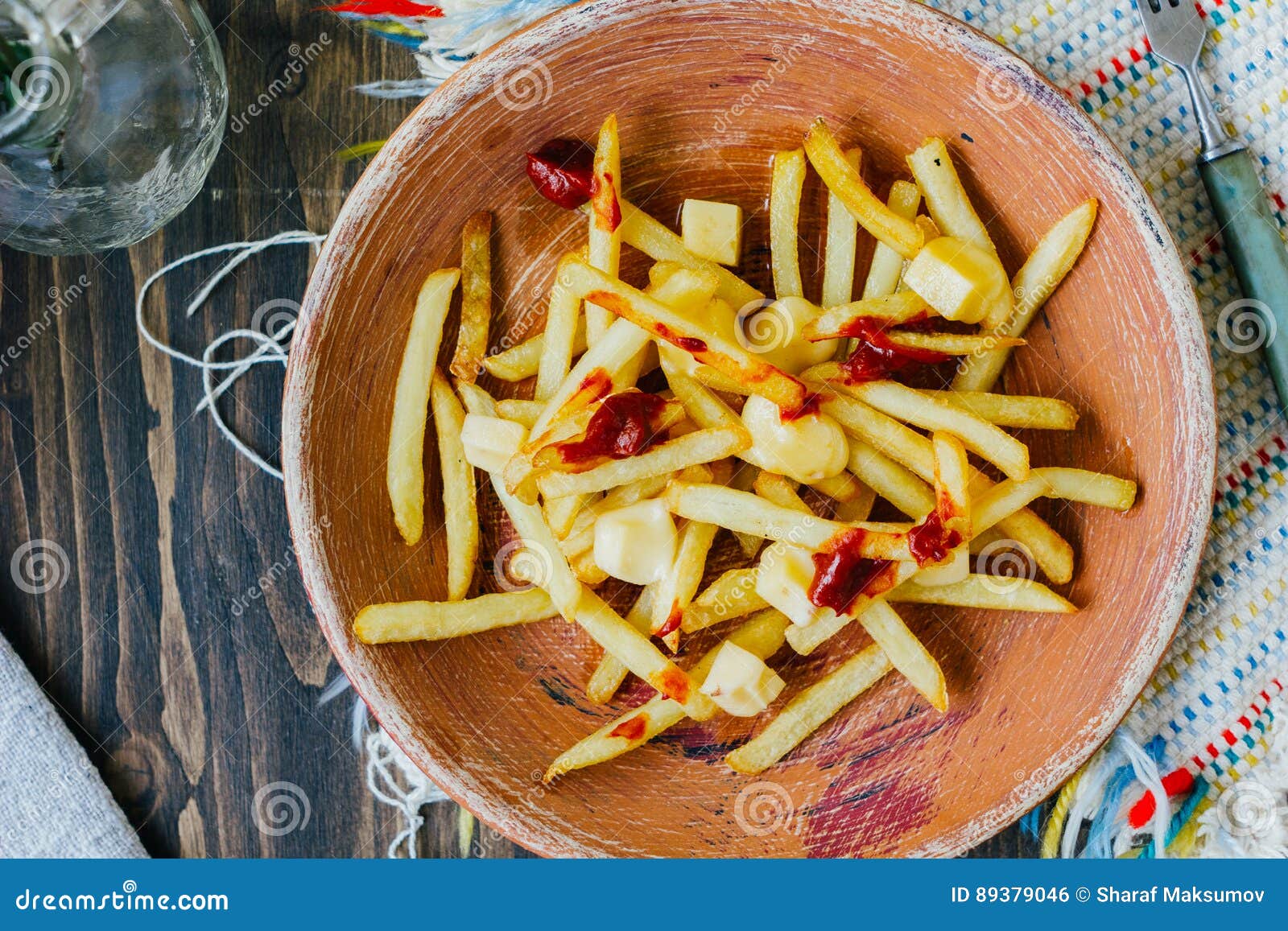 Poutine Fries on Black Surface. Canadian Dish with Potatoes, Cheese and