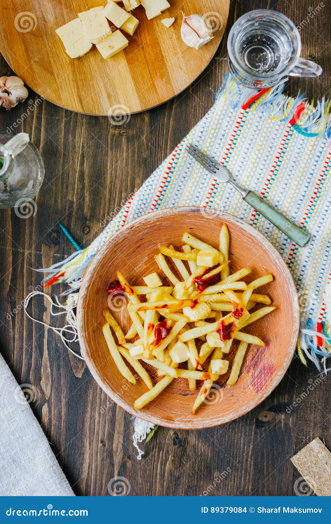 Poutine Fries on Black Surface. Canadian Dish with Potatoes, Cheese and