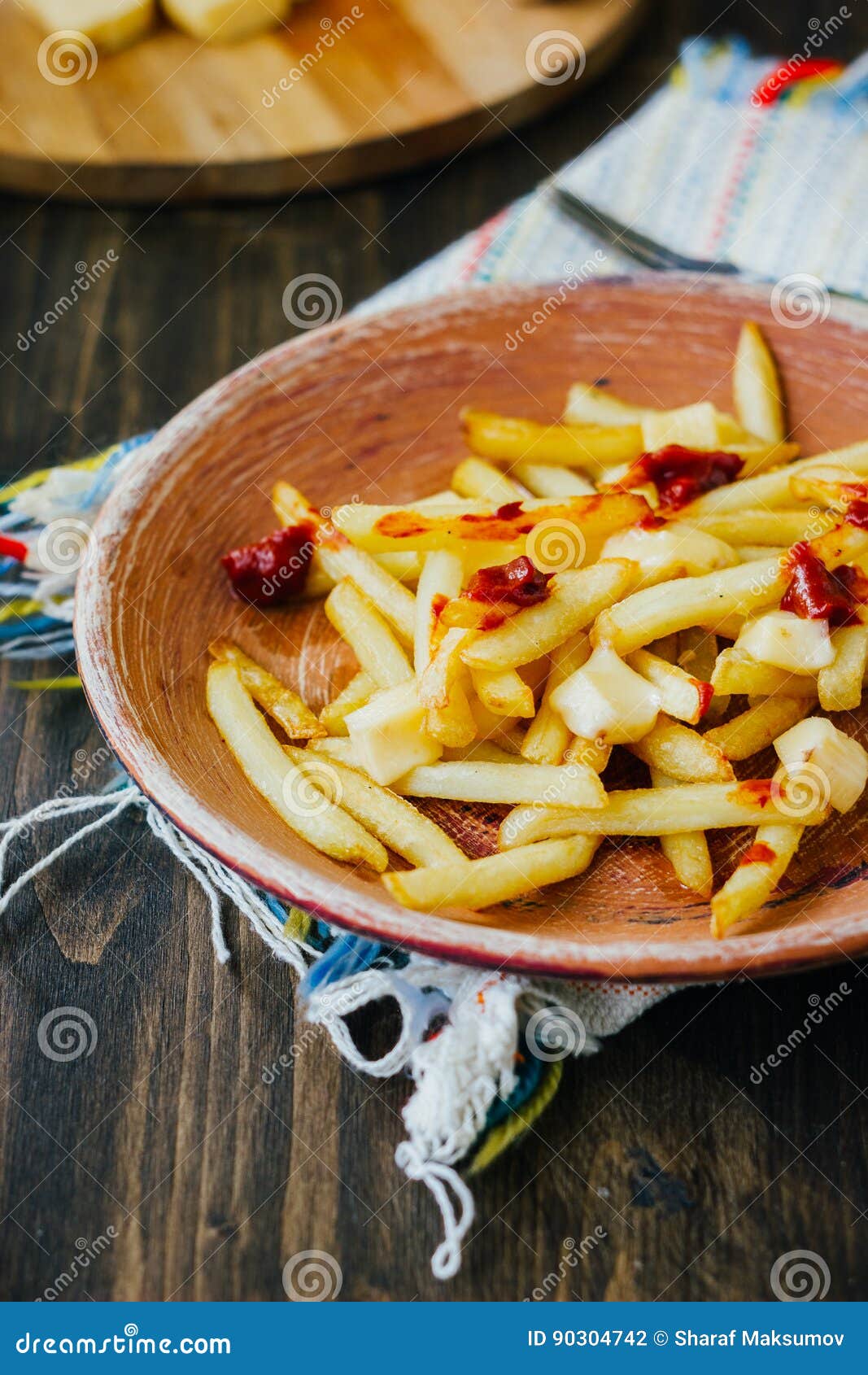 Poutine Fries on Black Surface. Canadian Dish with Potatoes, Cheese and
