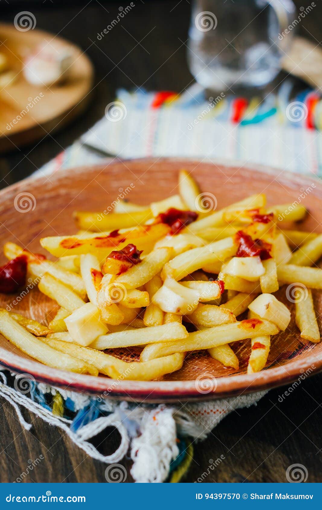 Poutine Fries on Black Surface. Canadian Dish with Potatoes, Cheese and