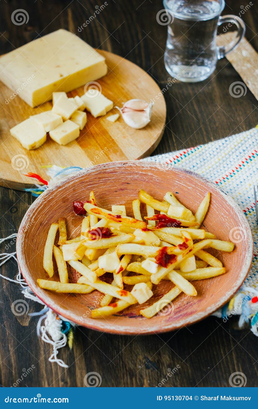 Poutine Fries on Black Surface. Canadian Dish with Potatoes, Cheese and