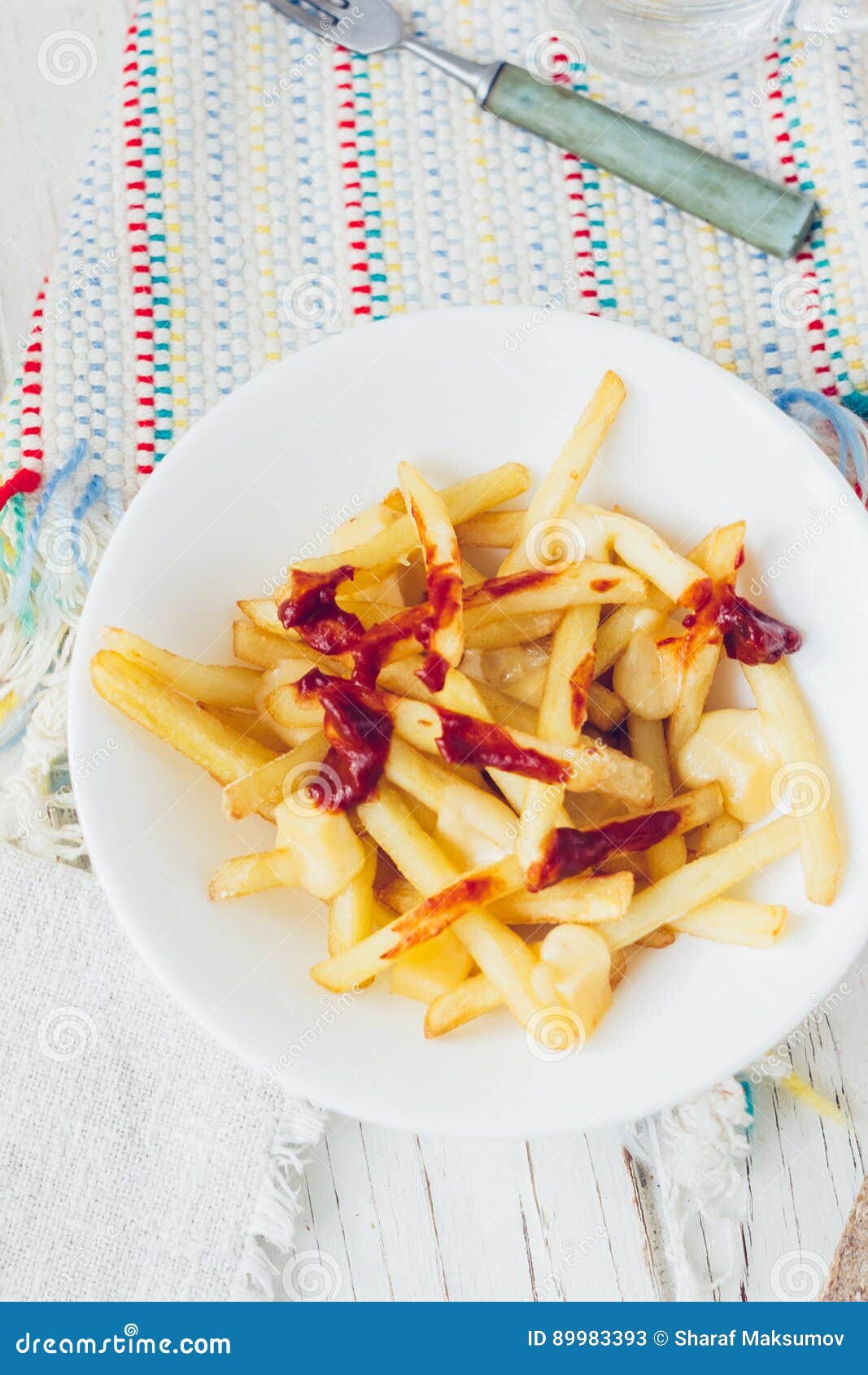 Poutine Fries with Tomato Sauce and Cheese on White Table. Stock Image ...