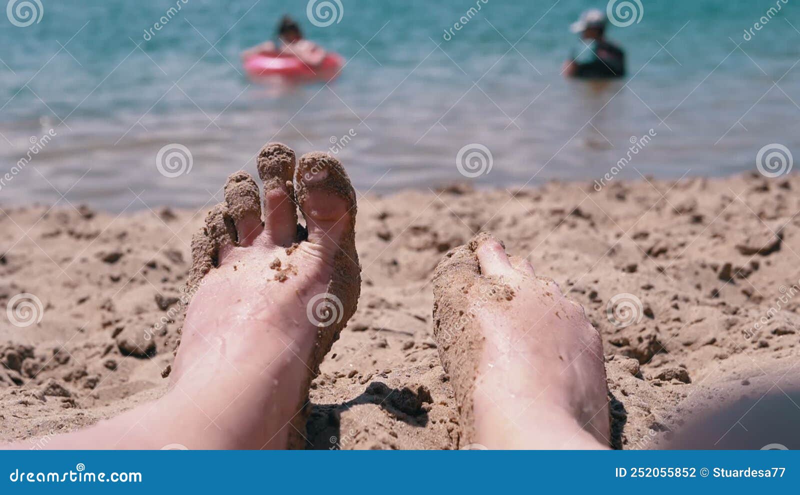 POV Female Wet Feet in Sand Lying on a Sandy Beach in Sun Glare Near ...