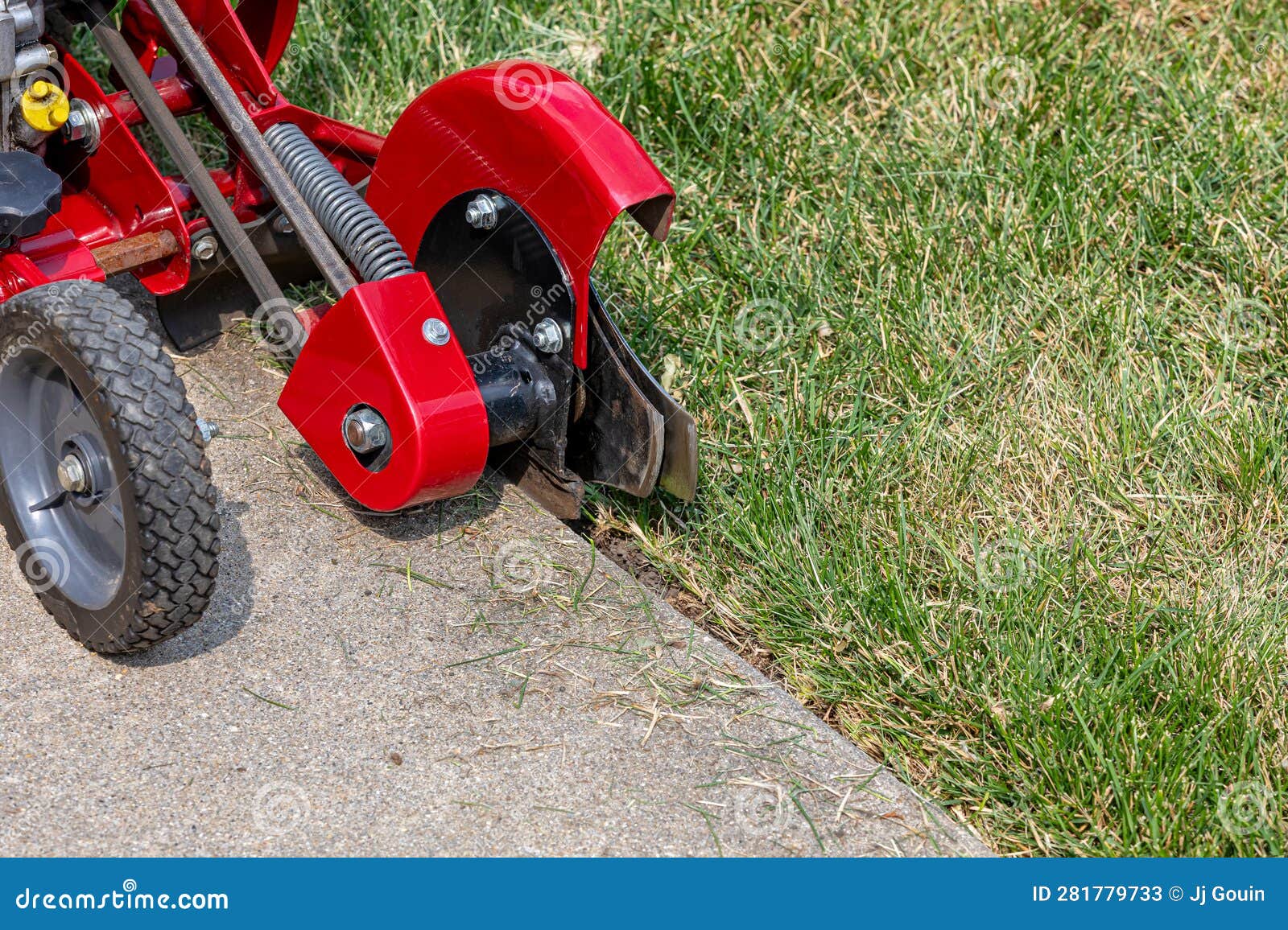 Power Lawn Edger Trimming Grass Along Sidewalk. Stock Image Image of