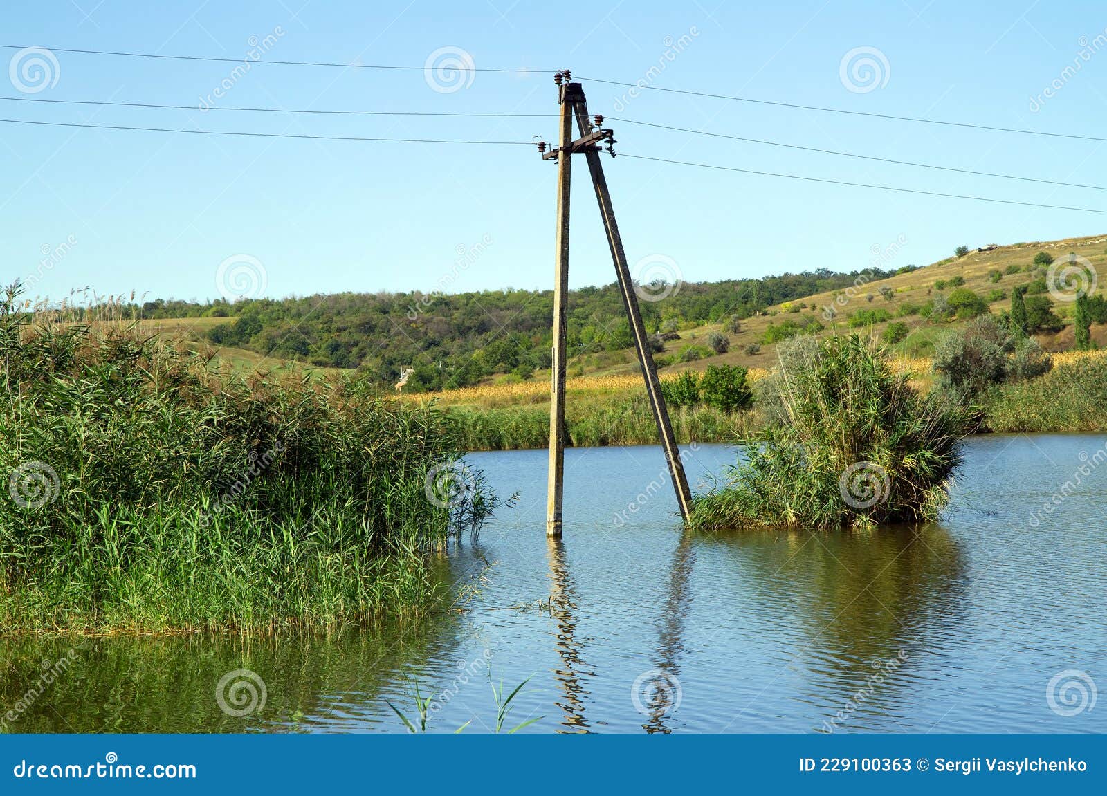 The Power Pole is Located in the Water of the Lake. Stock Image