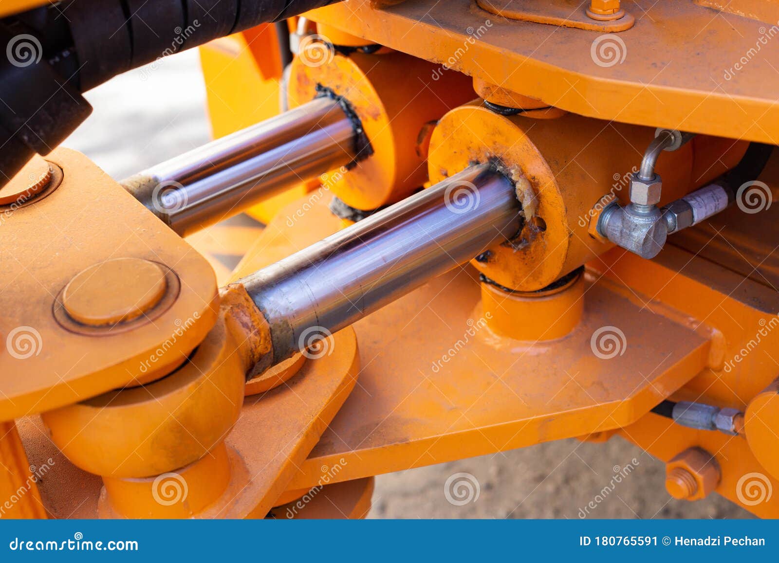 powerful hydraulic pumps that stand in the bucket of an excavator, industry, close-up, orange