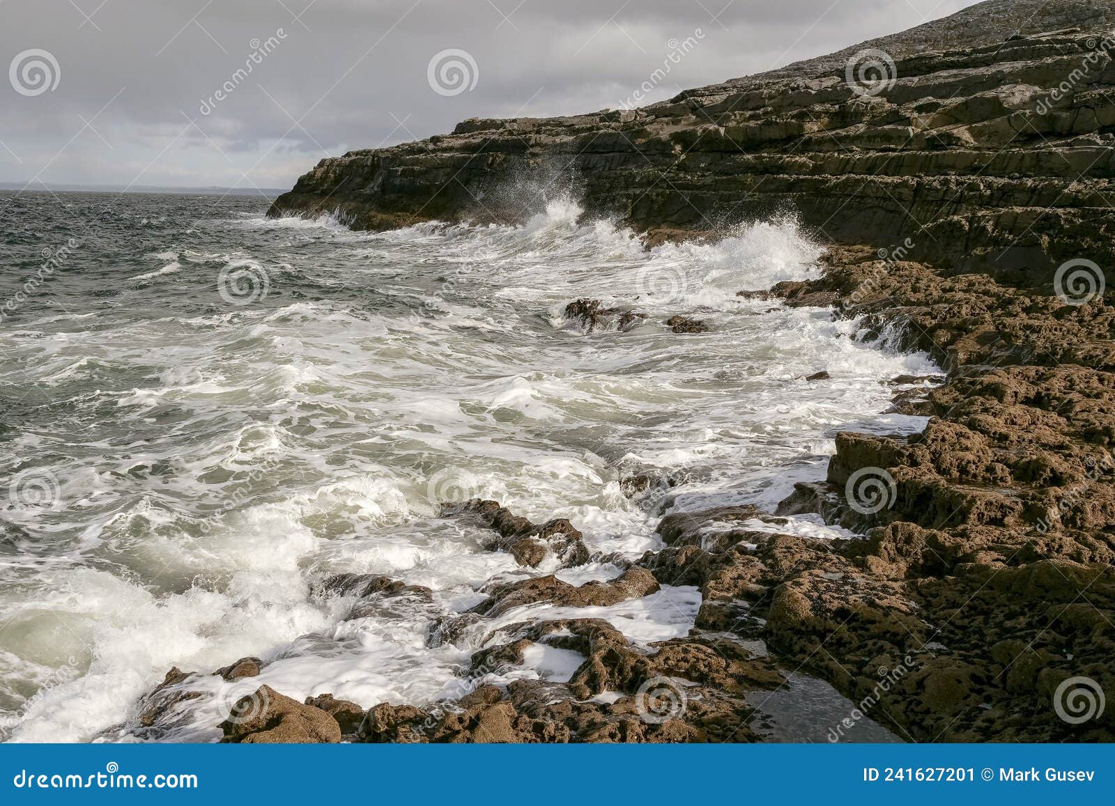 powerful ocean wave hit rough stone coast creating splash of water. west coast of ireland. burren area. irish landscape