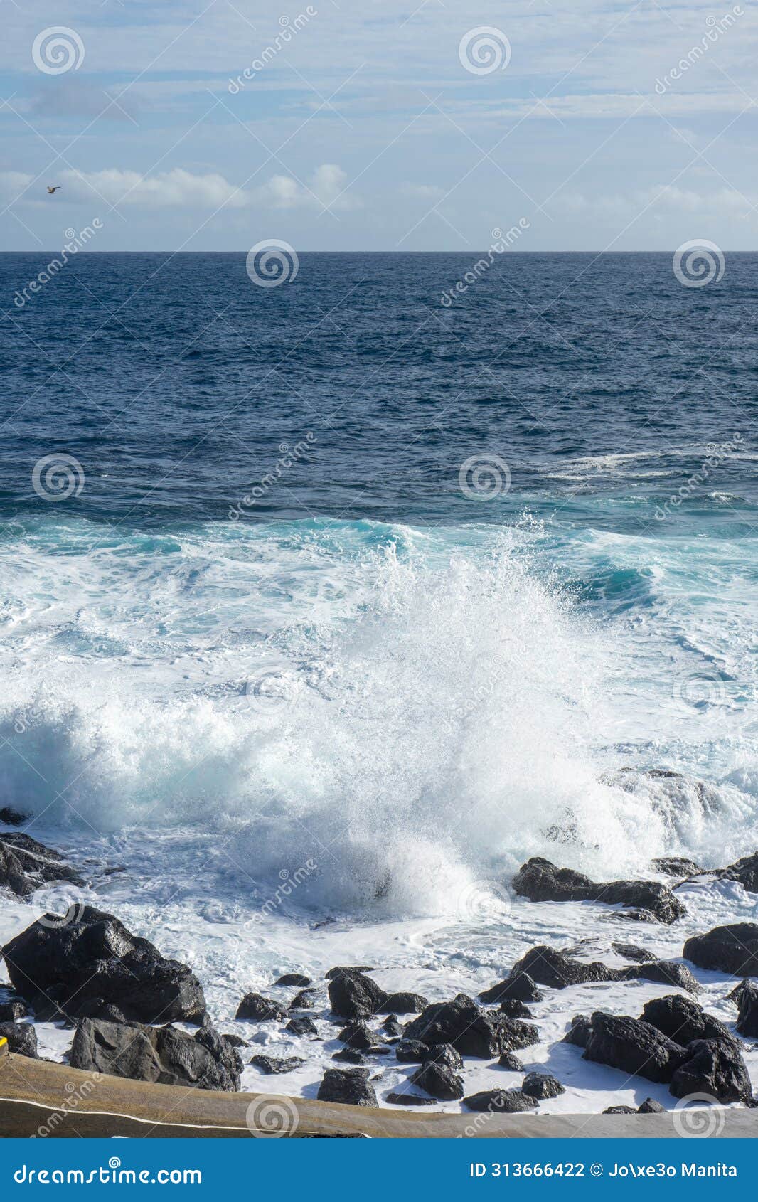 powerful waves crash along the shoreline of cinco ribeiras.