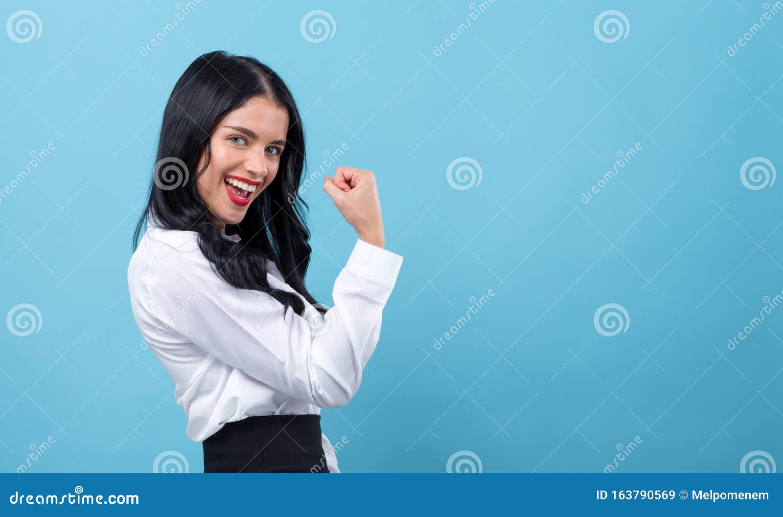 powerful young woman in success pose