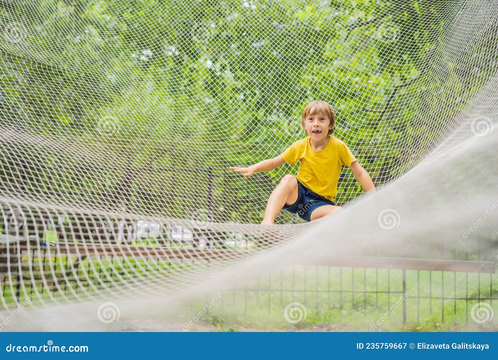 Practice Nets Playground. Boy Plays in the Playground Shielded with a