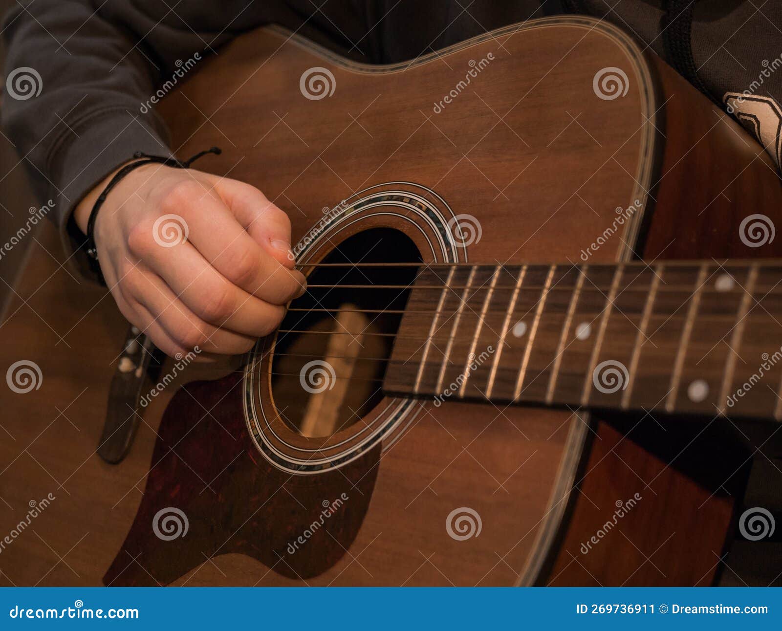 Practice Playing the Acoustic Guitar. Hands Playing Guitar and Picking Chords Stock Image