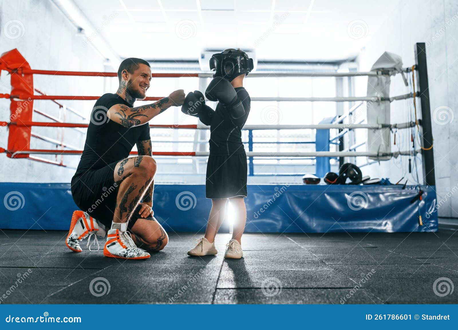 Practicing the Punches. Coach is Teaching the Boy Box Techniques