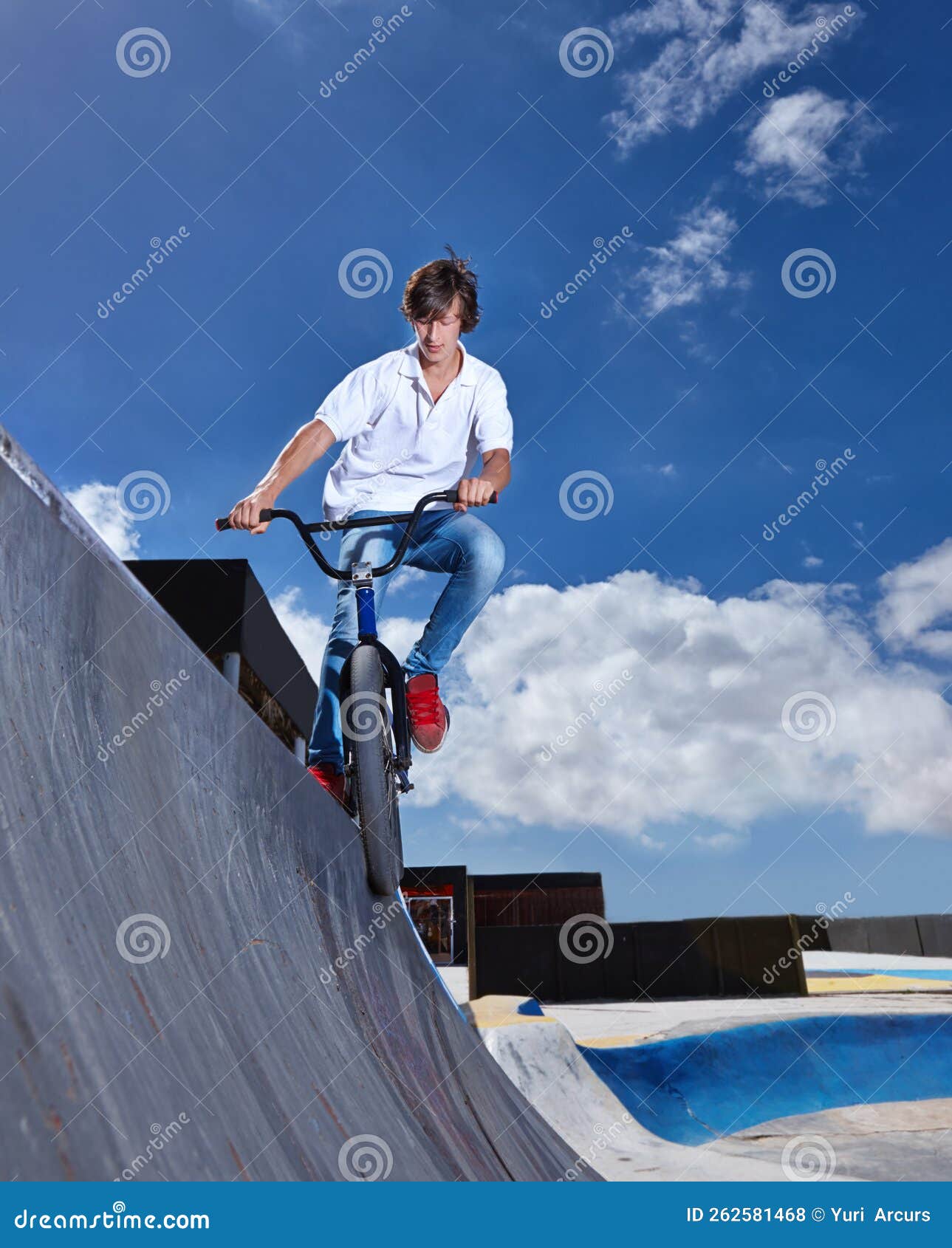practicing for the x games. full length shot of a teenage boy riding a bmx at a skatepark.