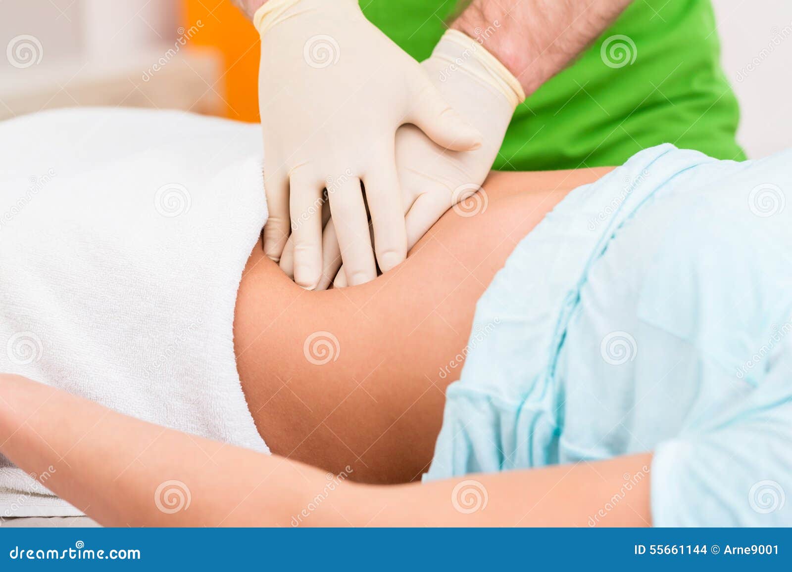 practitioner at colon therapy massaging abdomen