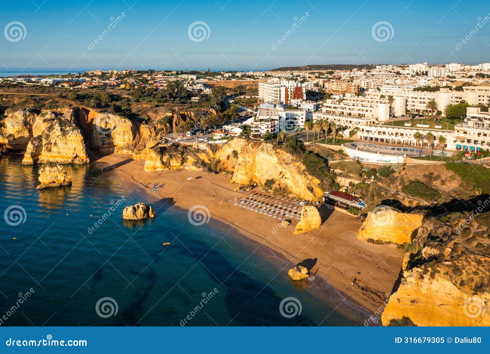 praia de dona ana beach with turquoise sea water and cliffs, portugal. beautiful dona ana beach (praia dona ana)