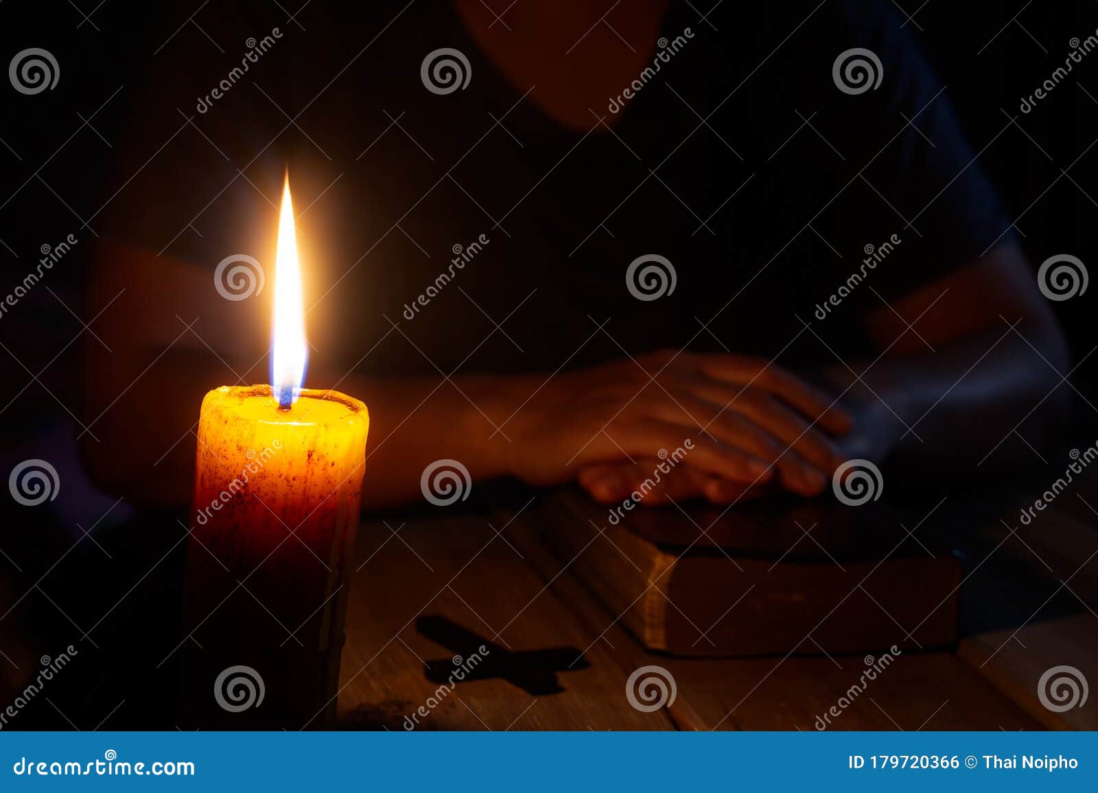 praying woman hands on old holy bible