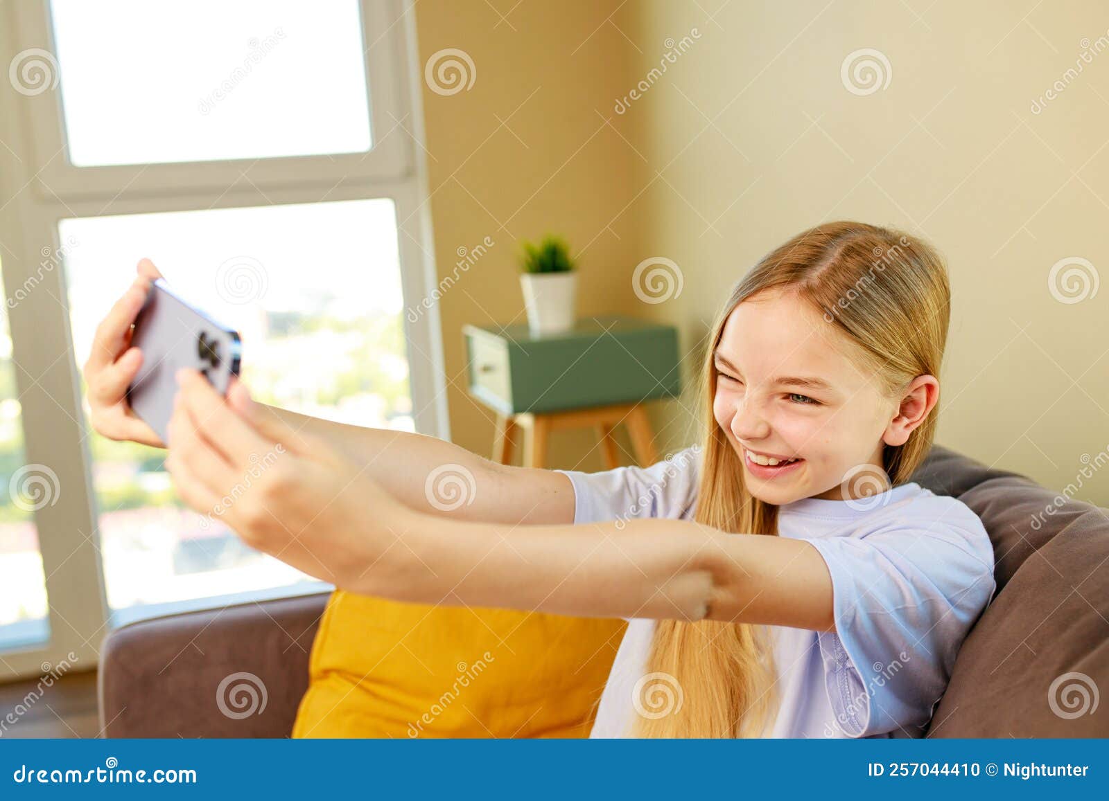 Pre-teen Girl Making Selfie Photos on Her Smartphone in Cozy Living ...