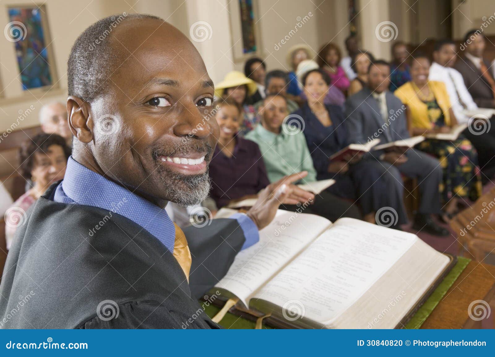 preacher at altar with bible preaching to congregation portrait close up