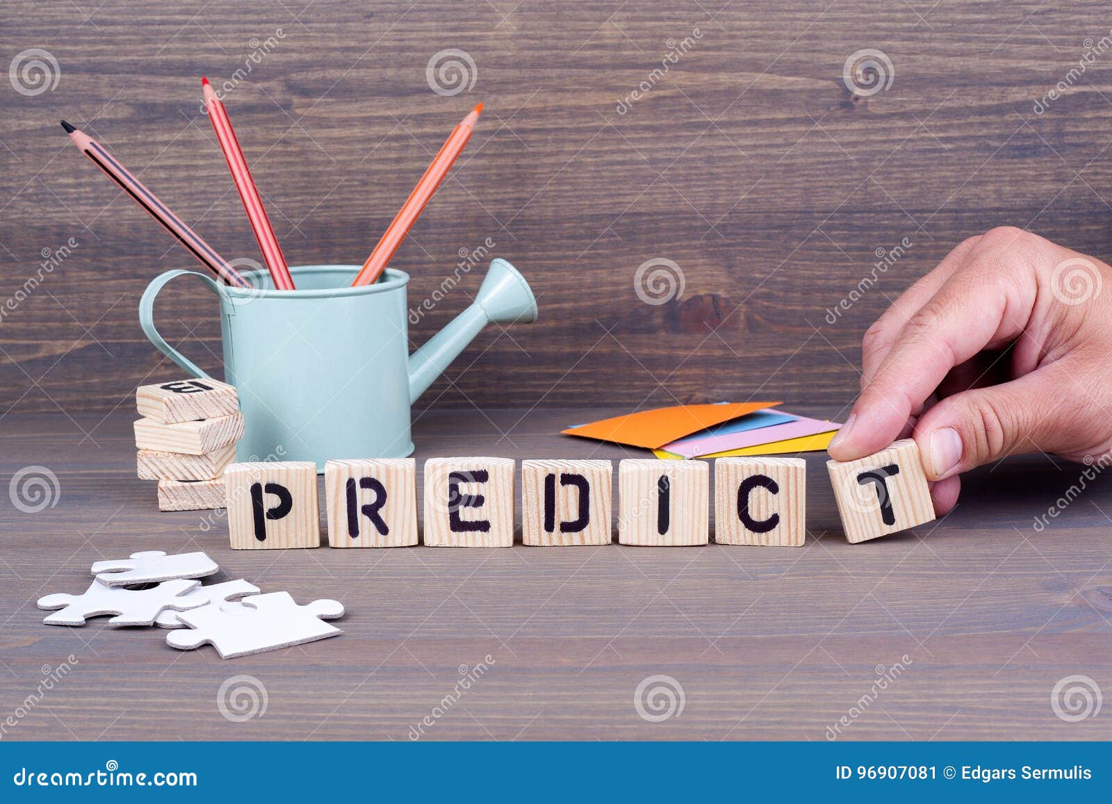 predict. wooden letters on dark background