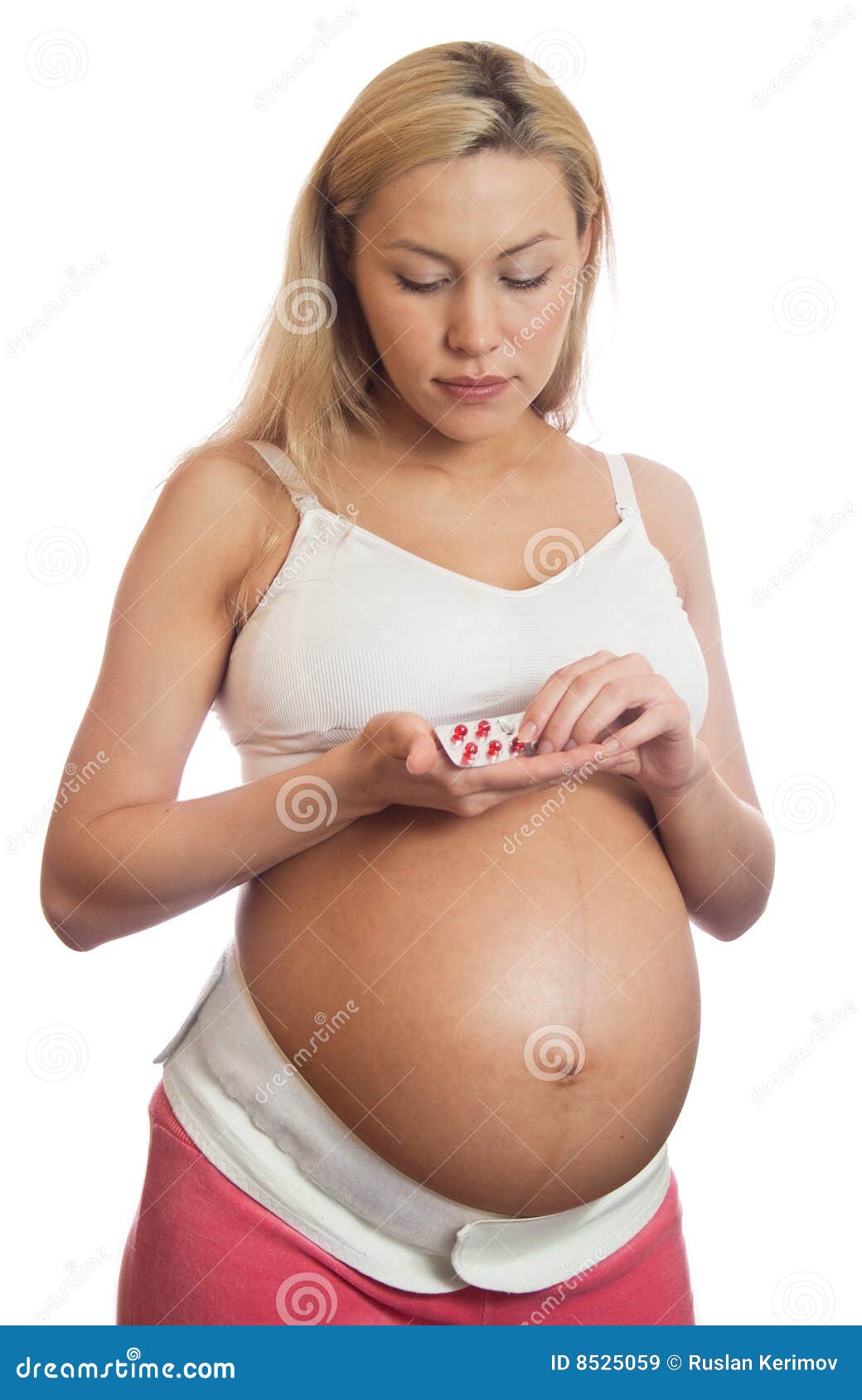 Close Up of Pregnant Woman in White Underwear Putting on a Bandage