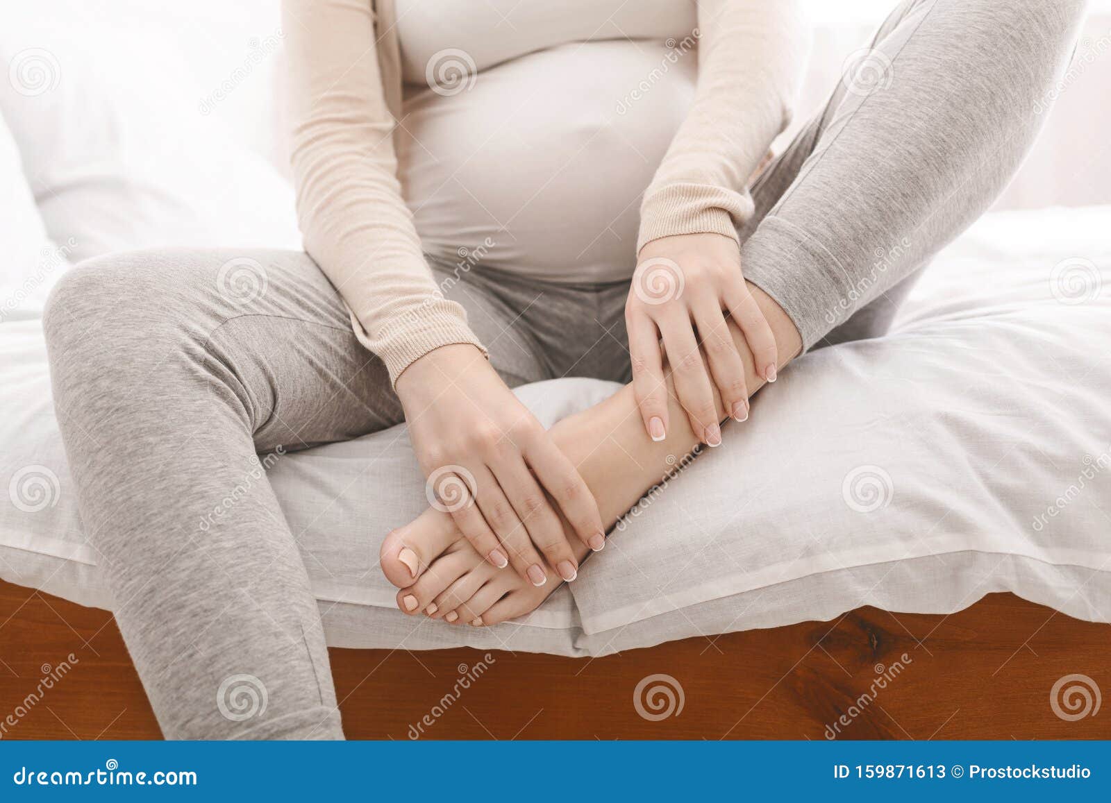 Pregnant Woman Massaging Her Swollen Foot Sitting On Bed Stock Image Image Of Female Joint