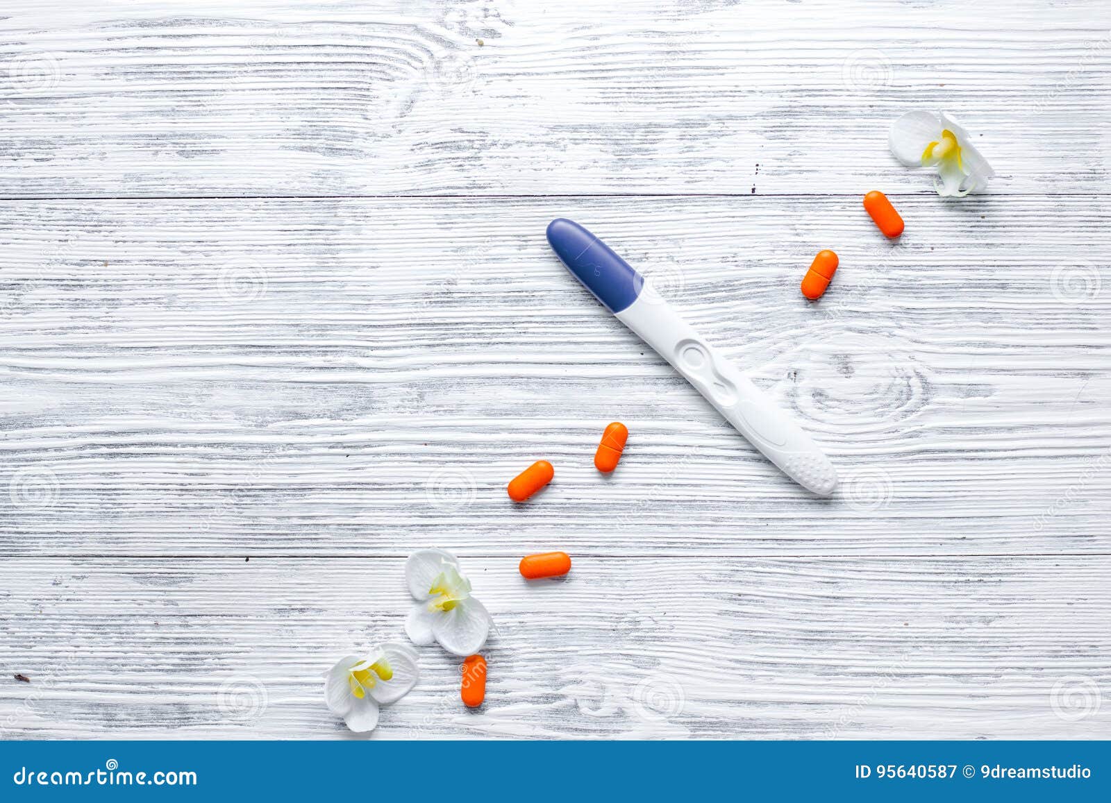 Pregnancy Test and Pills on Wooden Background Top View Copyspace Stock