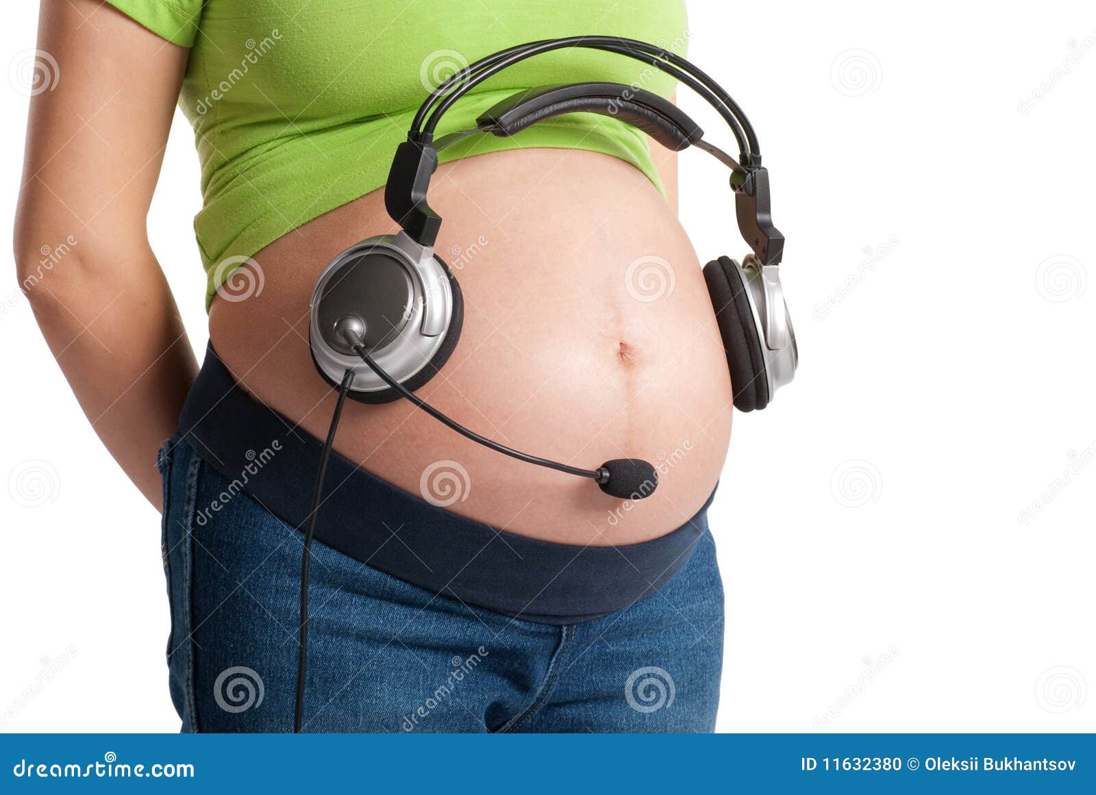 Pretty Pregnant Woman Putting Headphones On Her Belly Stock Photo, Picture  and Royalty Free Image. Image 59147162.