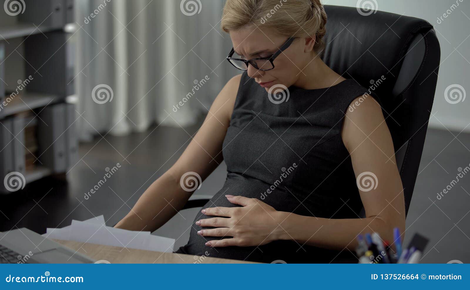 pregnant business woman hardly breathing in office, preterm birth, health care