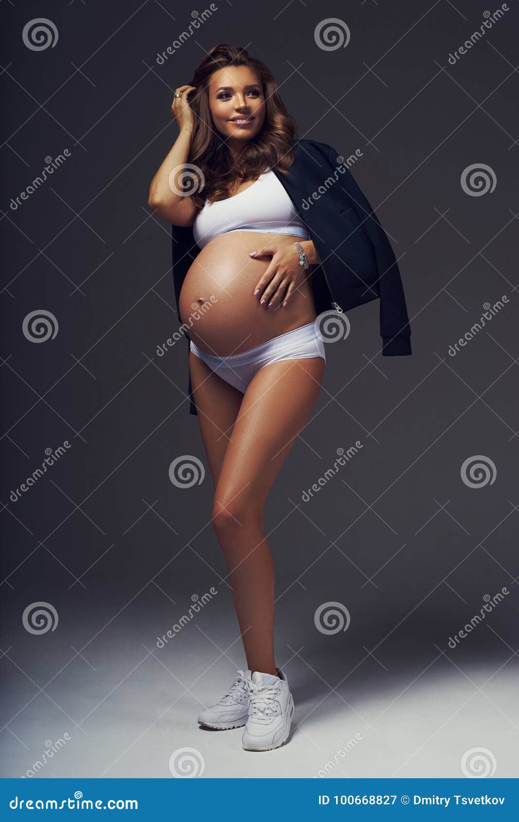 Pregnant Female Model in Sports Underwear Standing and Posing