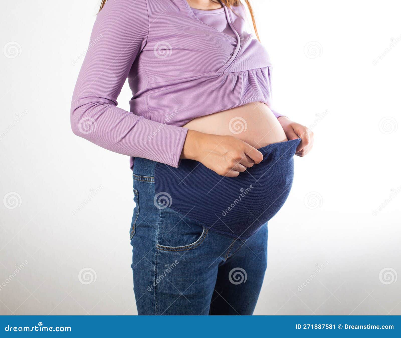 Pregnant Girl with a Big Belly in Jeans on a White Background. the Concept  of Comfortable Clothes for Pregnant Women, Universal Stock Image - Image of  corset, medical: 271887581