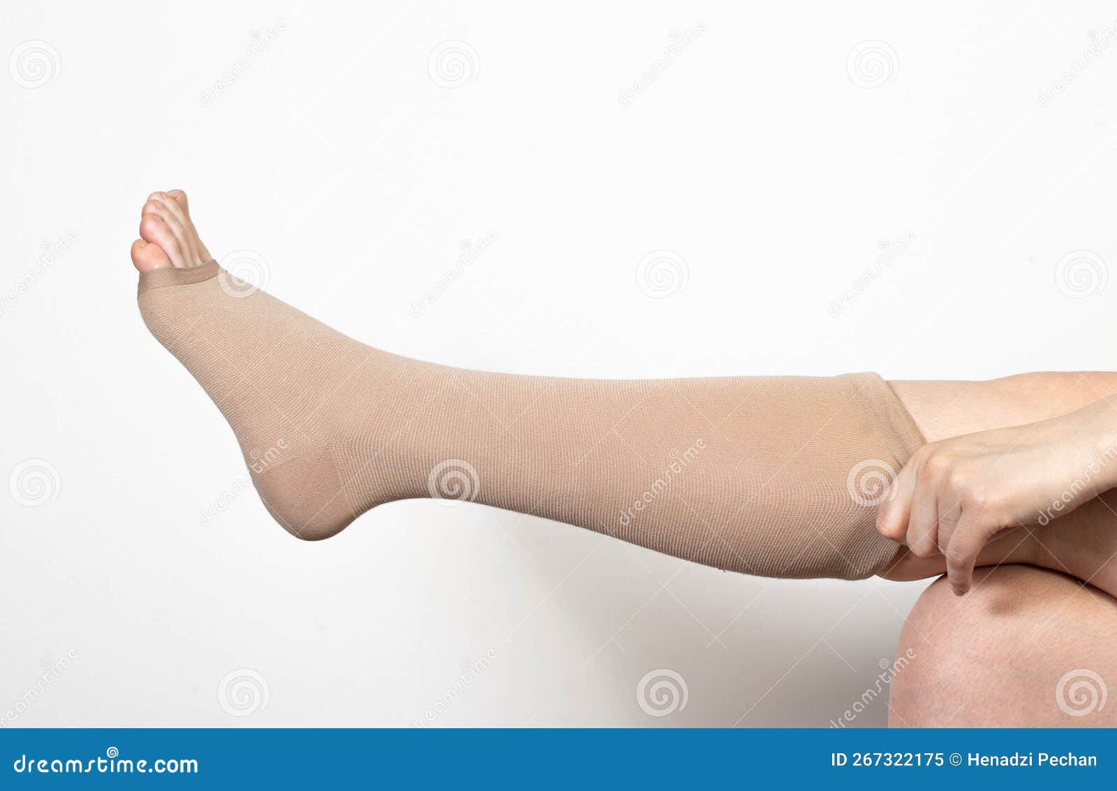 Pregnant Girl Puts on Compression Stockings for Varicose Veins on