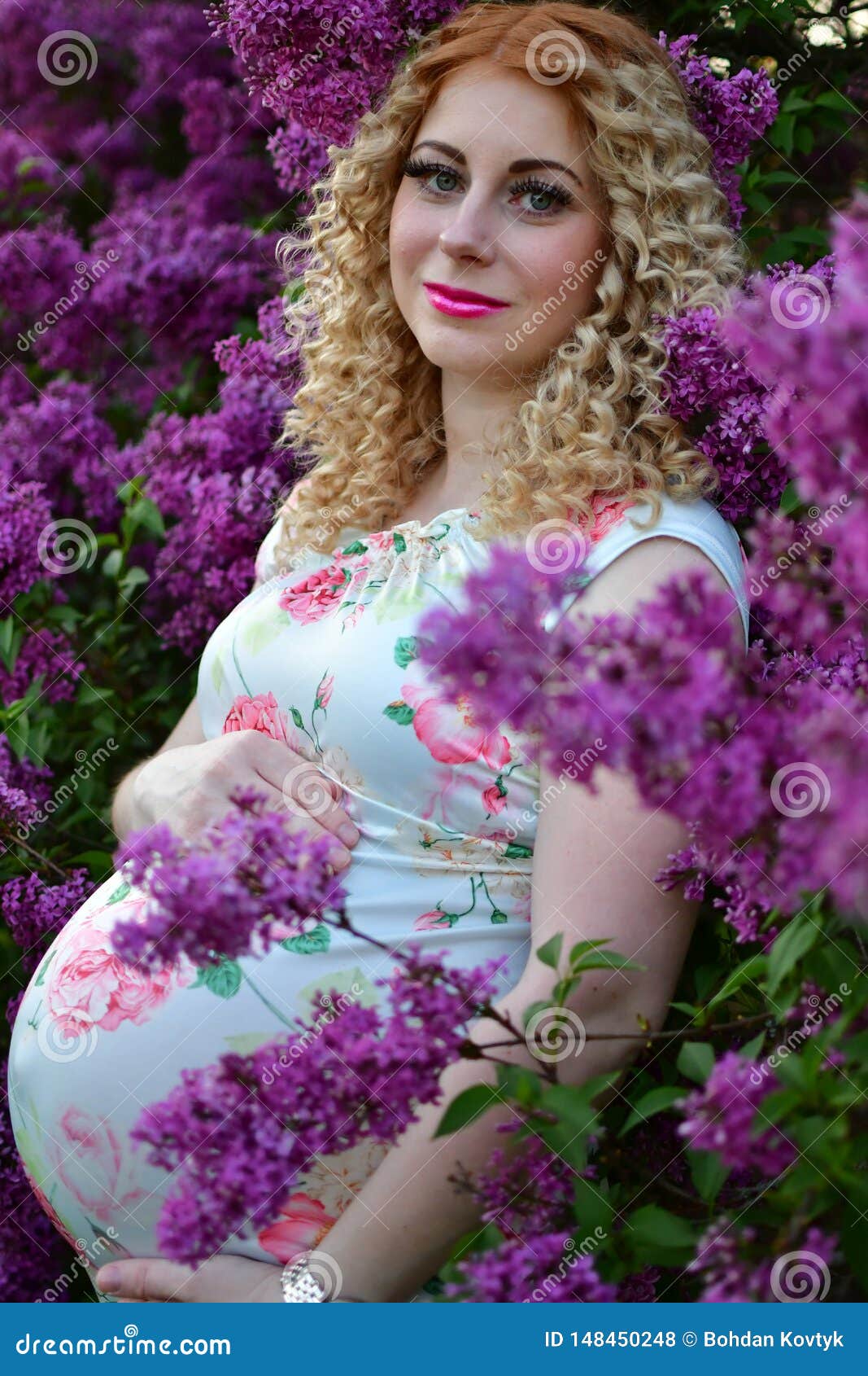 Pregnant Girl Smiling in a Blooming Spring Park, the Girl is Walking in ...