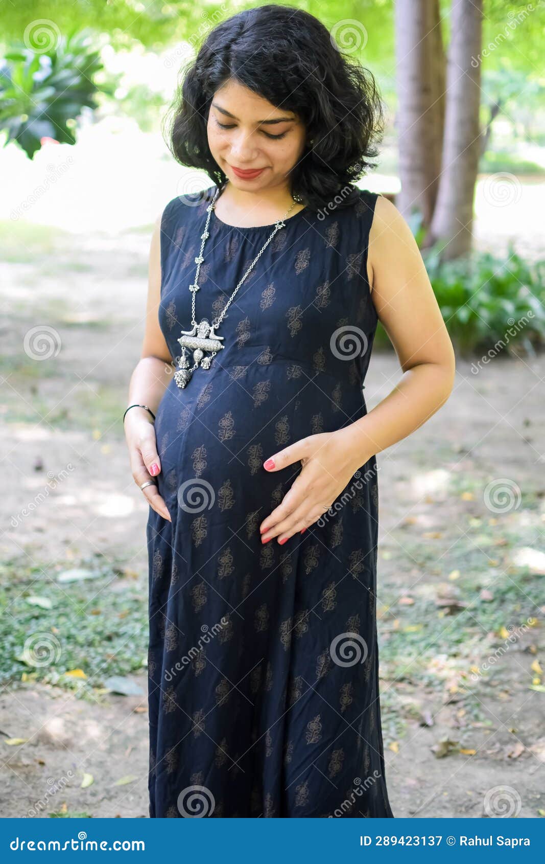 A Pregnant Indian Lady Poses For Outdoor Pregnancy Shoot And Hands On Belly Indian Pregnant