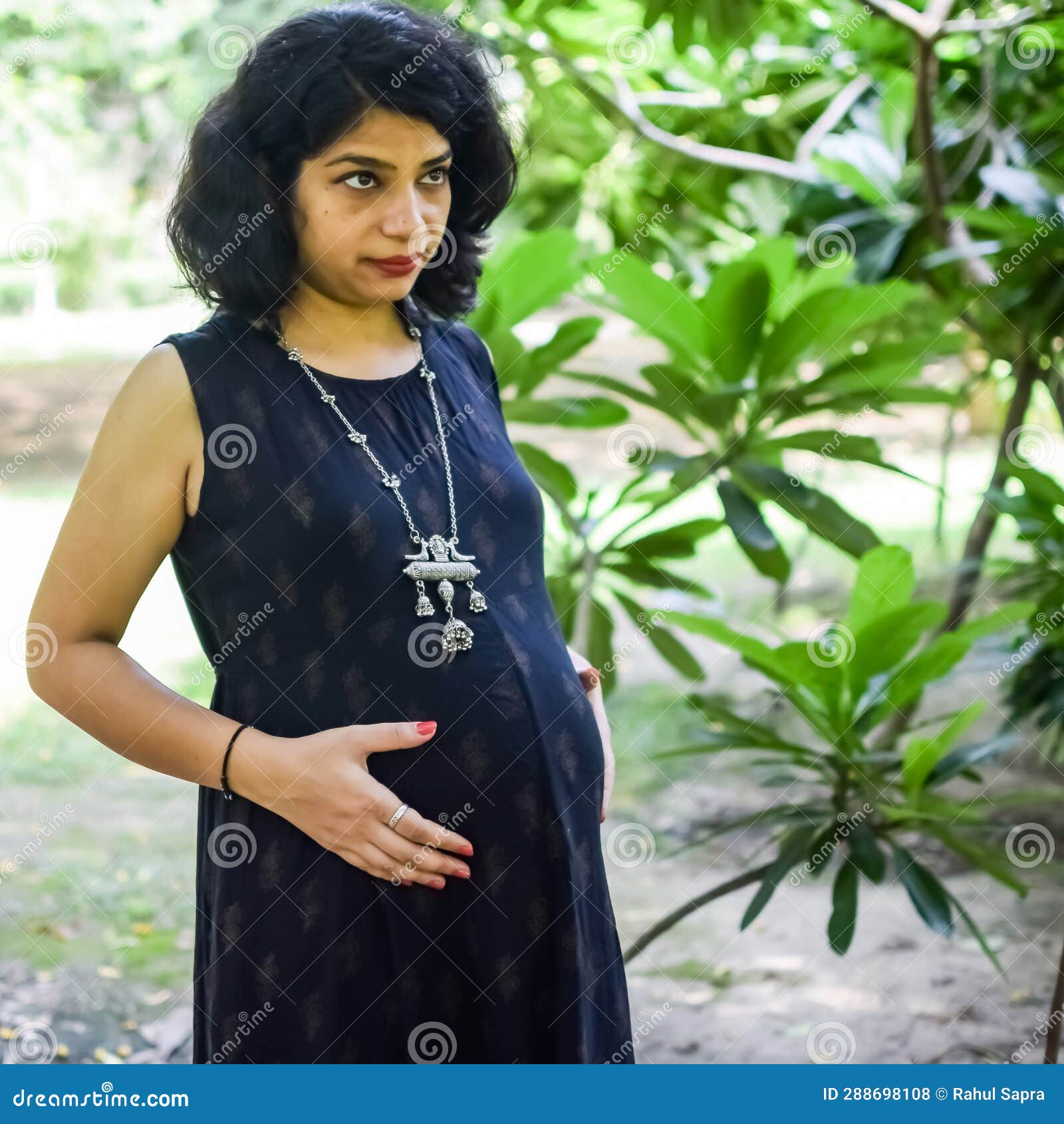 A Pregnant Indian Lady Poses For Outdoor Pregnancy Shoot And Hands On Belly Indian Pregnant