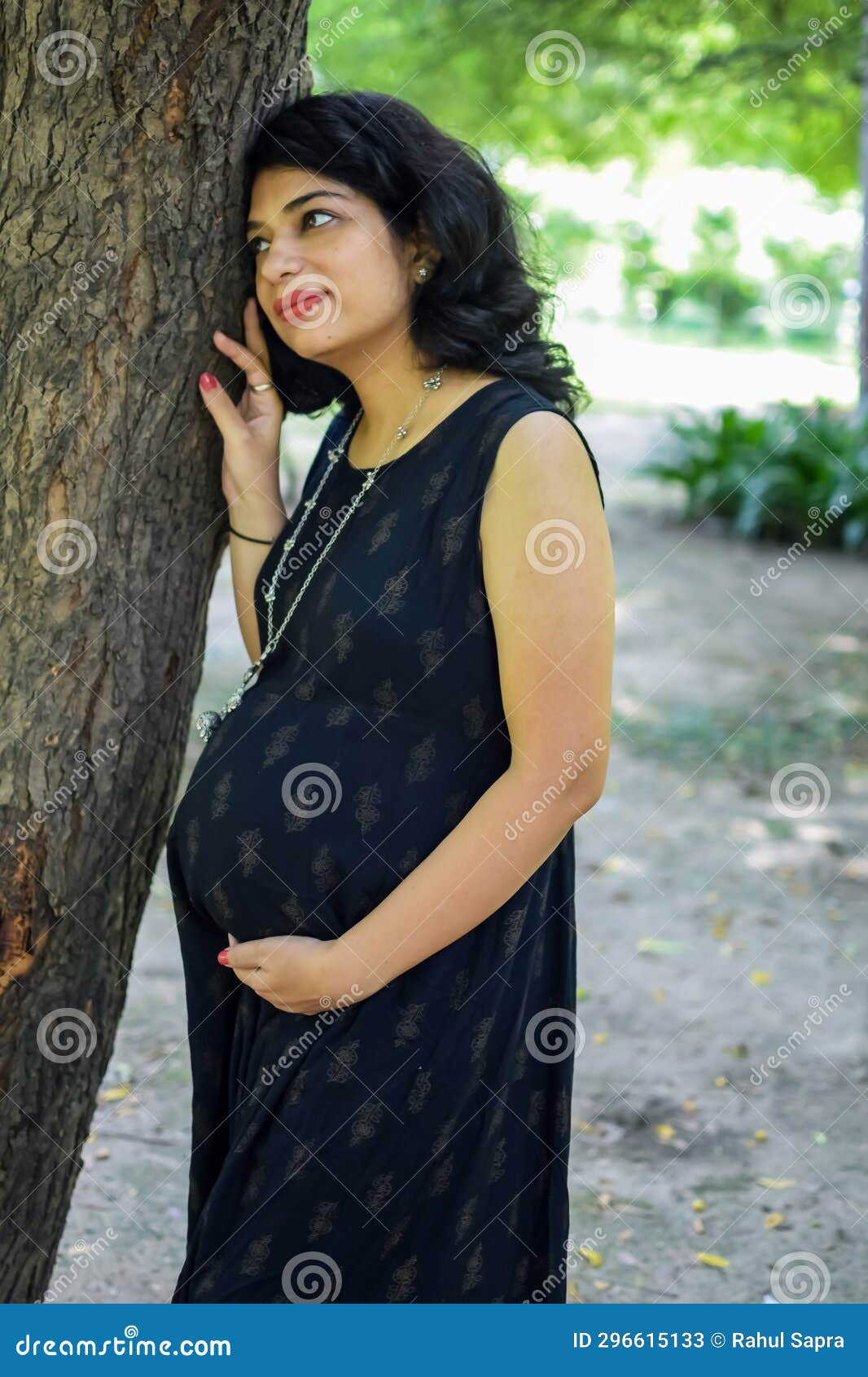 https://thumbs.dreamstime.com/z/pregnant-indian-lady-poses-outdoor-pregnancy-shoot-hands-belly-woman-puts-her-hand-stomach-maternity-dress-296615133.jpg