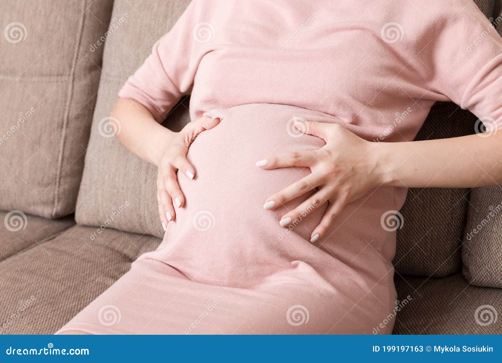 Pregnant Lady Having Massaging Lower Belly Sitting on Sofa Indoor. Pregnancy  Problems Concept Stock Image - Image of disease, belly: 199197163