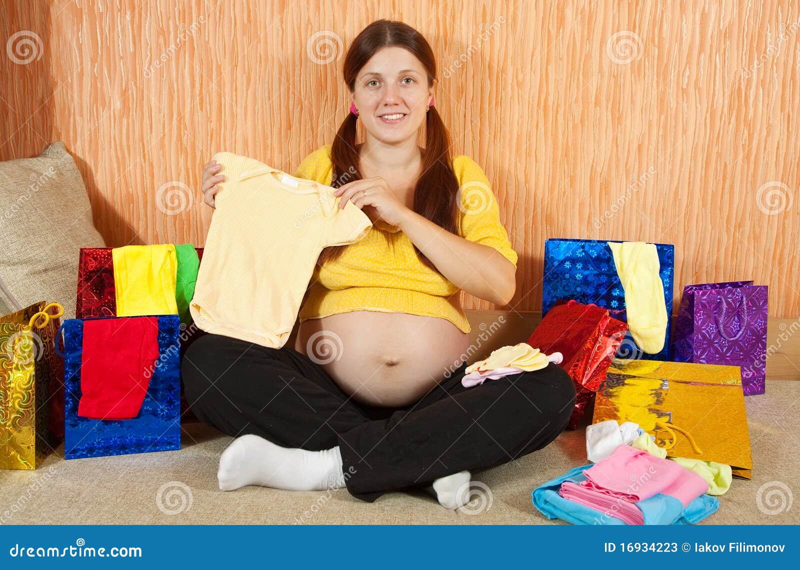 Pregnant Woman With Babies Clothes Stock Image - Image of motherhood
