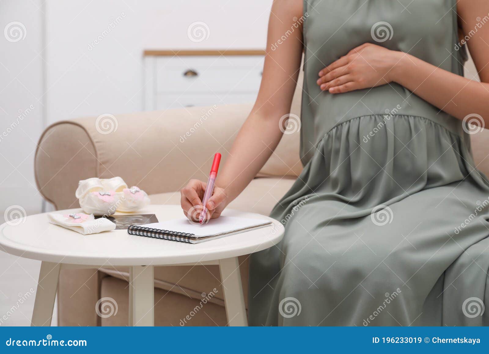 pregnant woman baby s accessories writing names list small white table pregnant woman baby s accessories writing 196233019