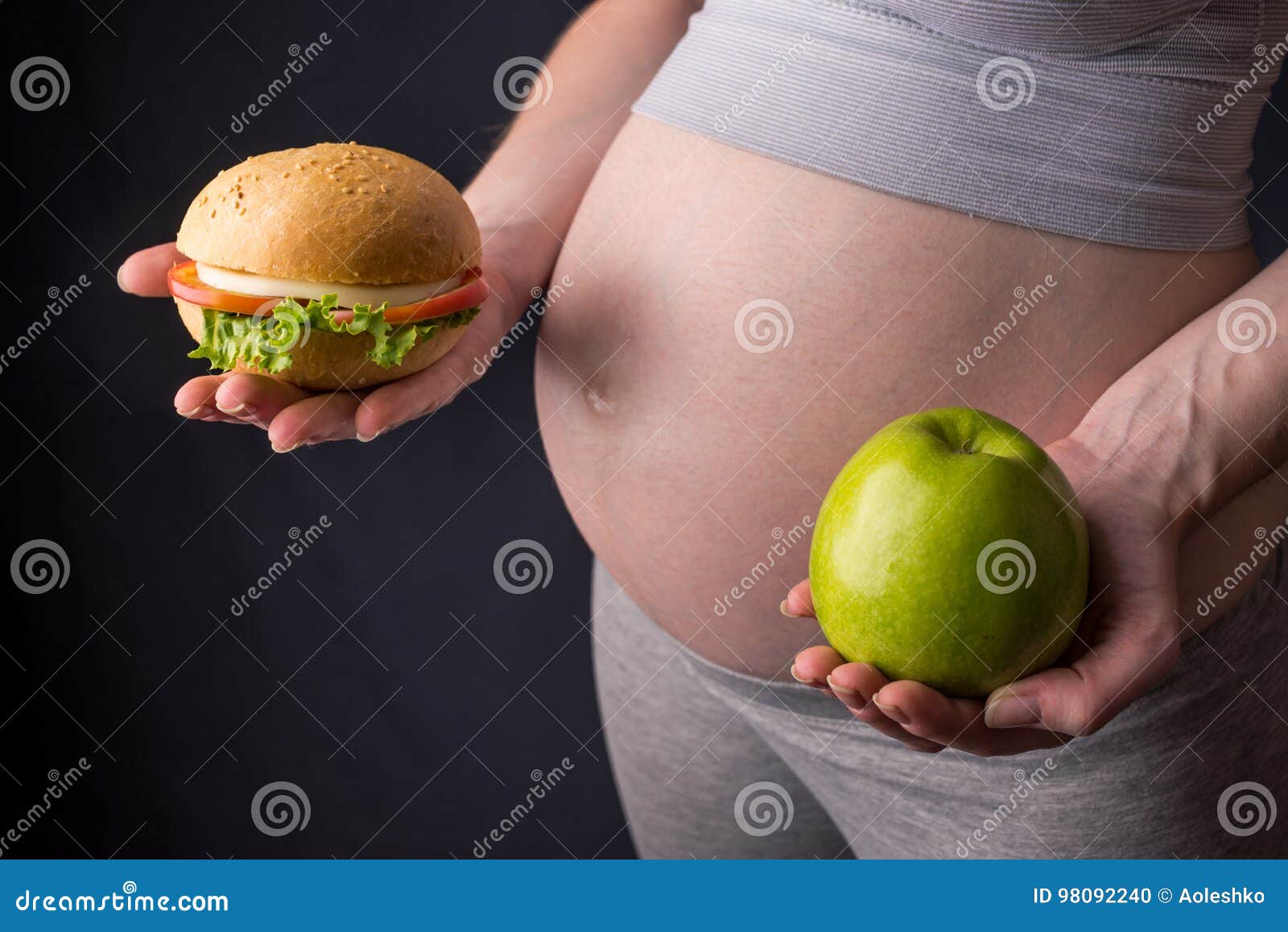 Pregnant Woman Belly Holding A Plate With Junk And Healthy Food ... Pregnant Woman Belly Holding A Plate With Junk And Healthy Food ...