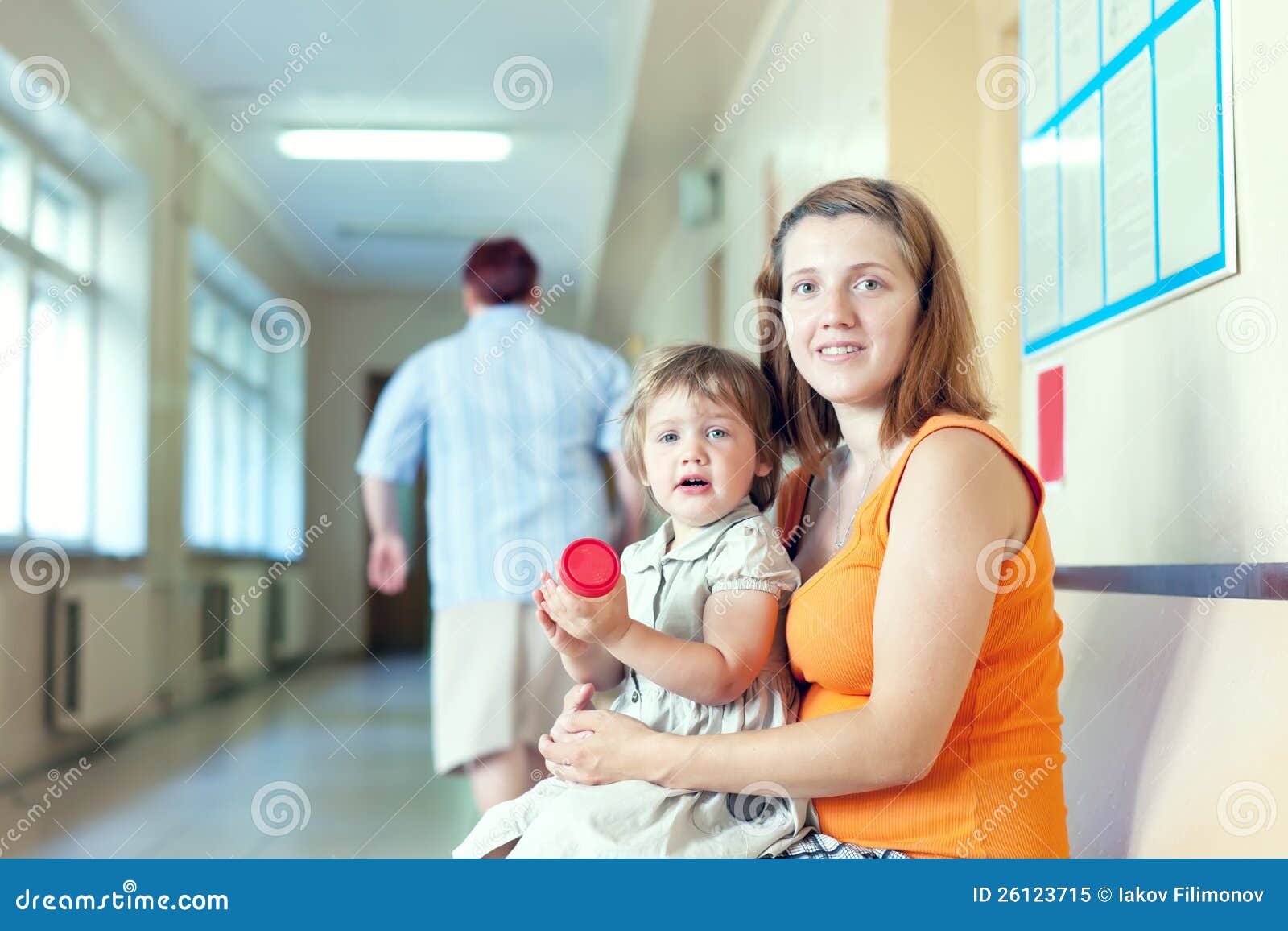 pregnant woman and child with urinalysis sample