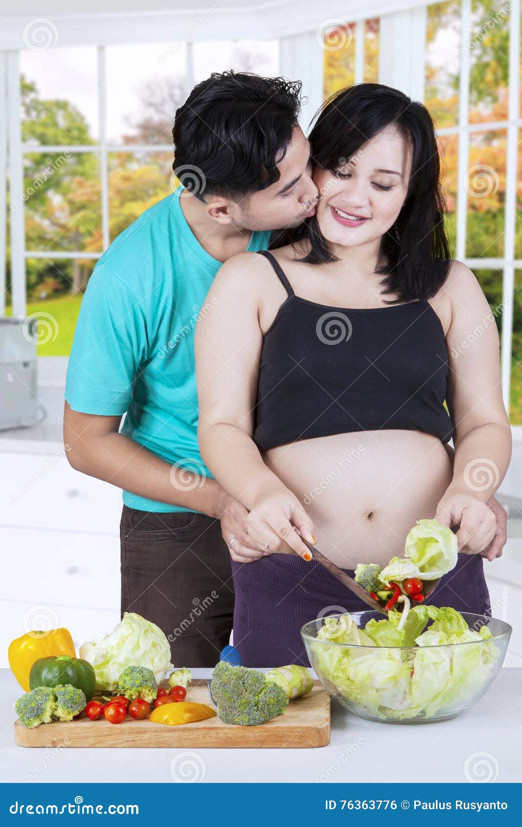 Pregnant Woman Cooking With Her H