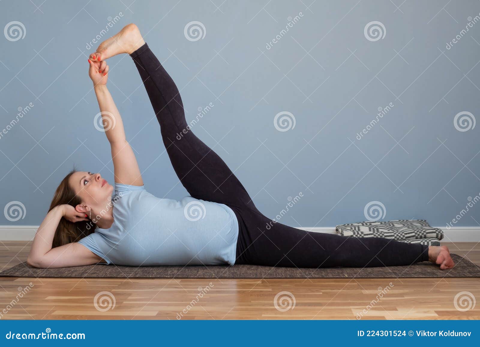 Pregnant Woman Doing Anantasana, Side Reclining Leg Lift Yoga Pose