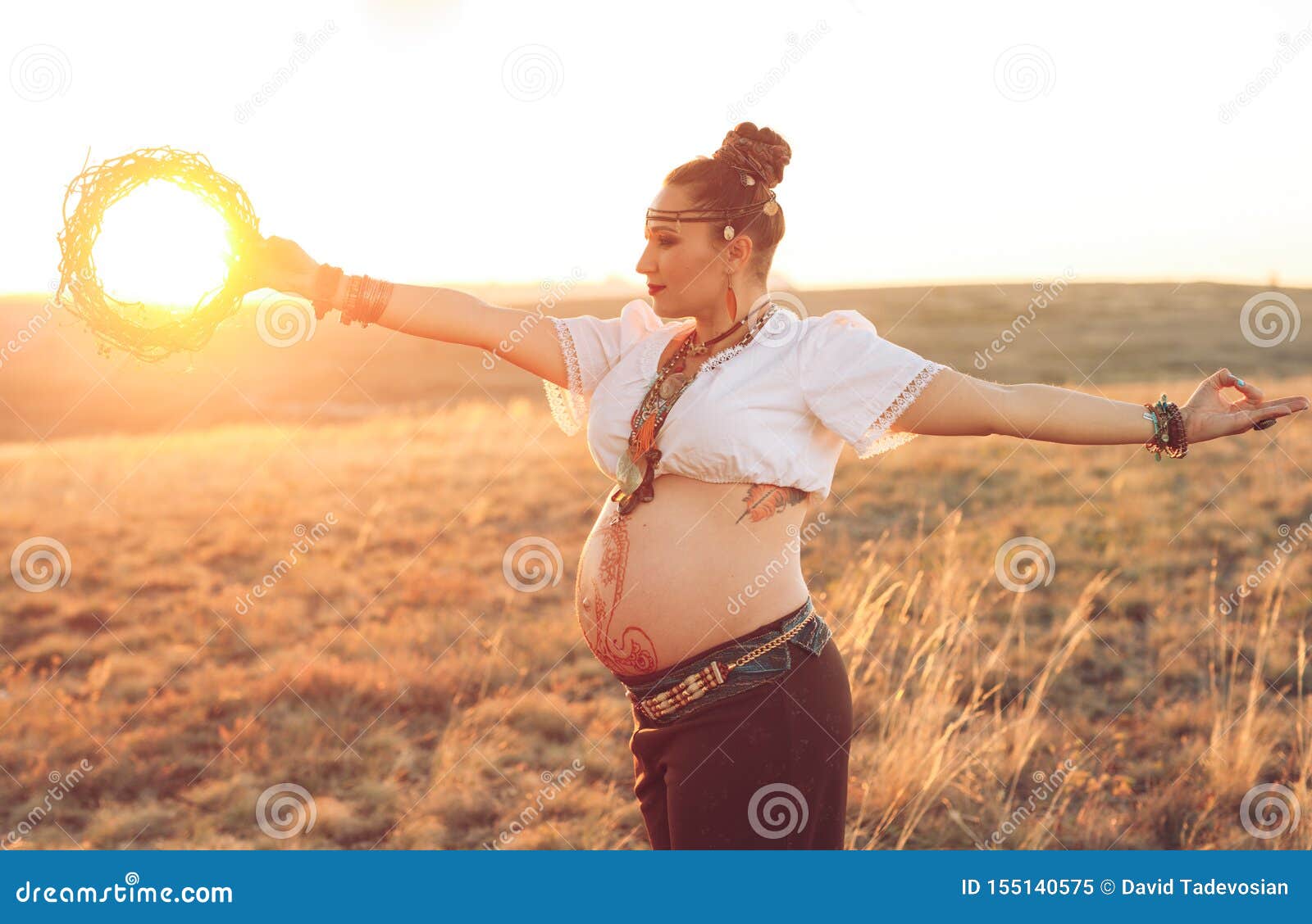 Pregnant Woman Doing Yoga in the Field at Sunset. Girl Holding a Dream ...