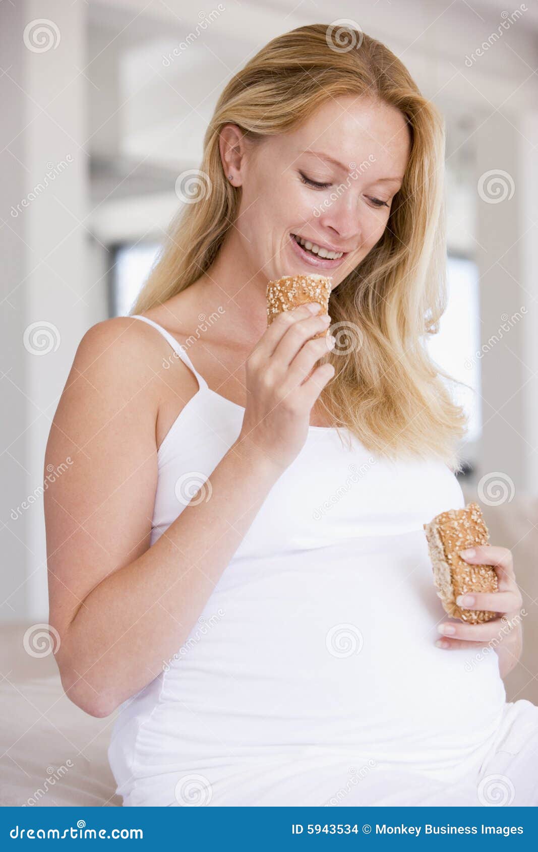 Pregnant Woman Eating Bread and Smiling Stock Photo Image of person