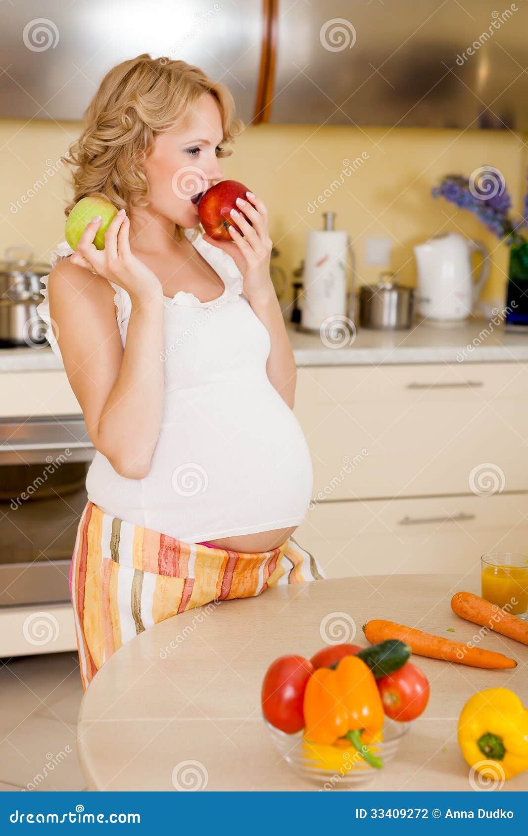 Pregnant woman eats apple stock photo. Image of family 33409272