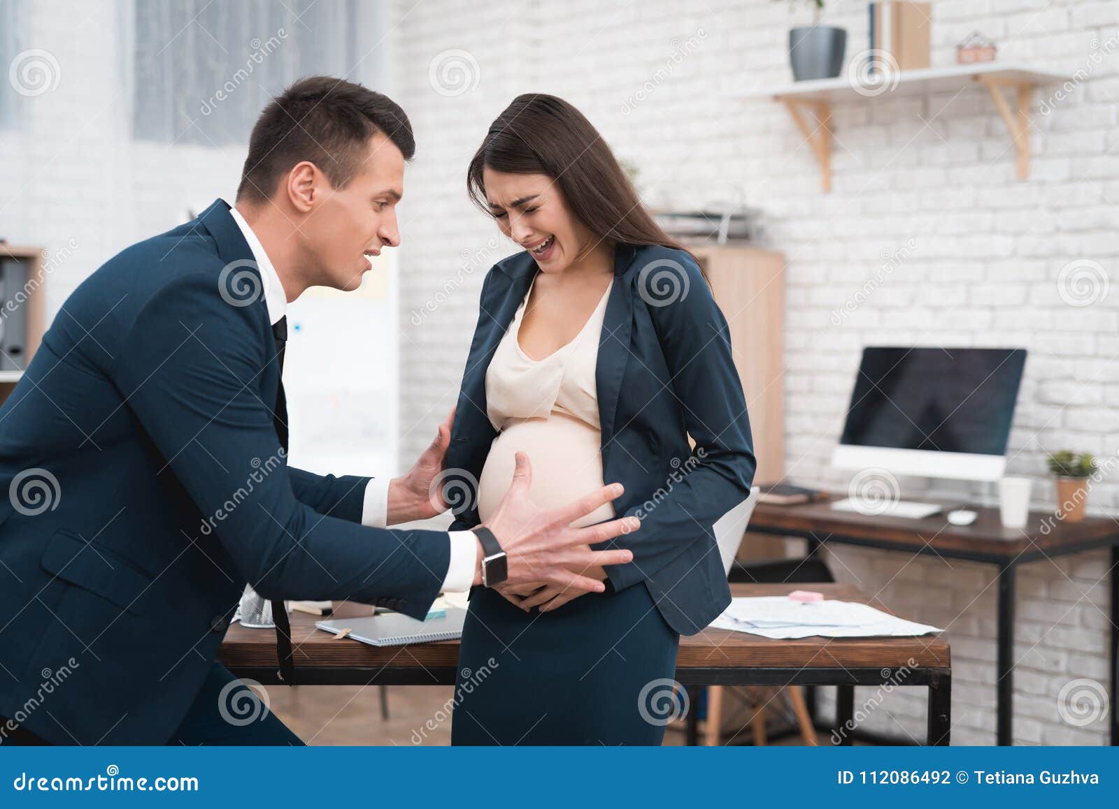 Pregnant Woman is Experiencing Labor in Office. Young Girl is ...