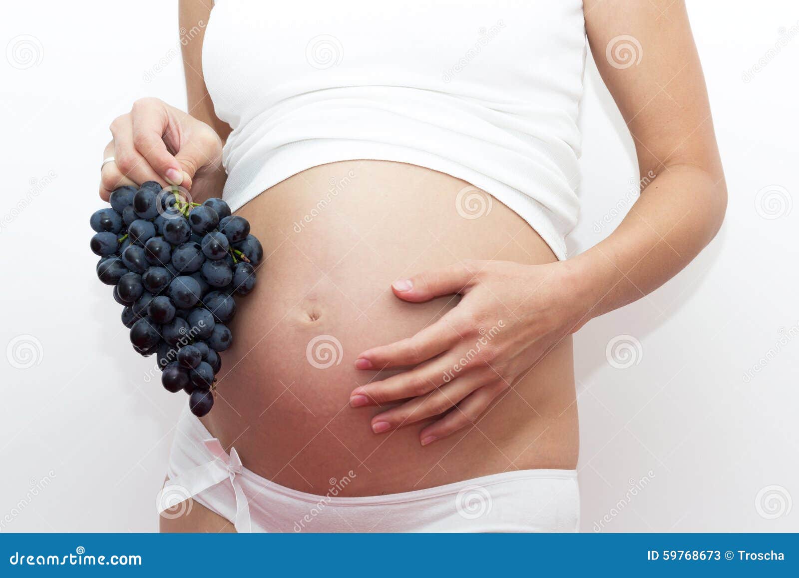 Pregnant woman with grape stock image. Image of indoors 59768673