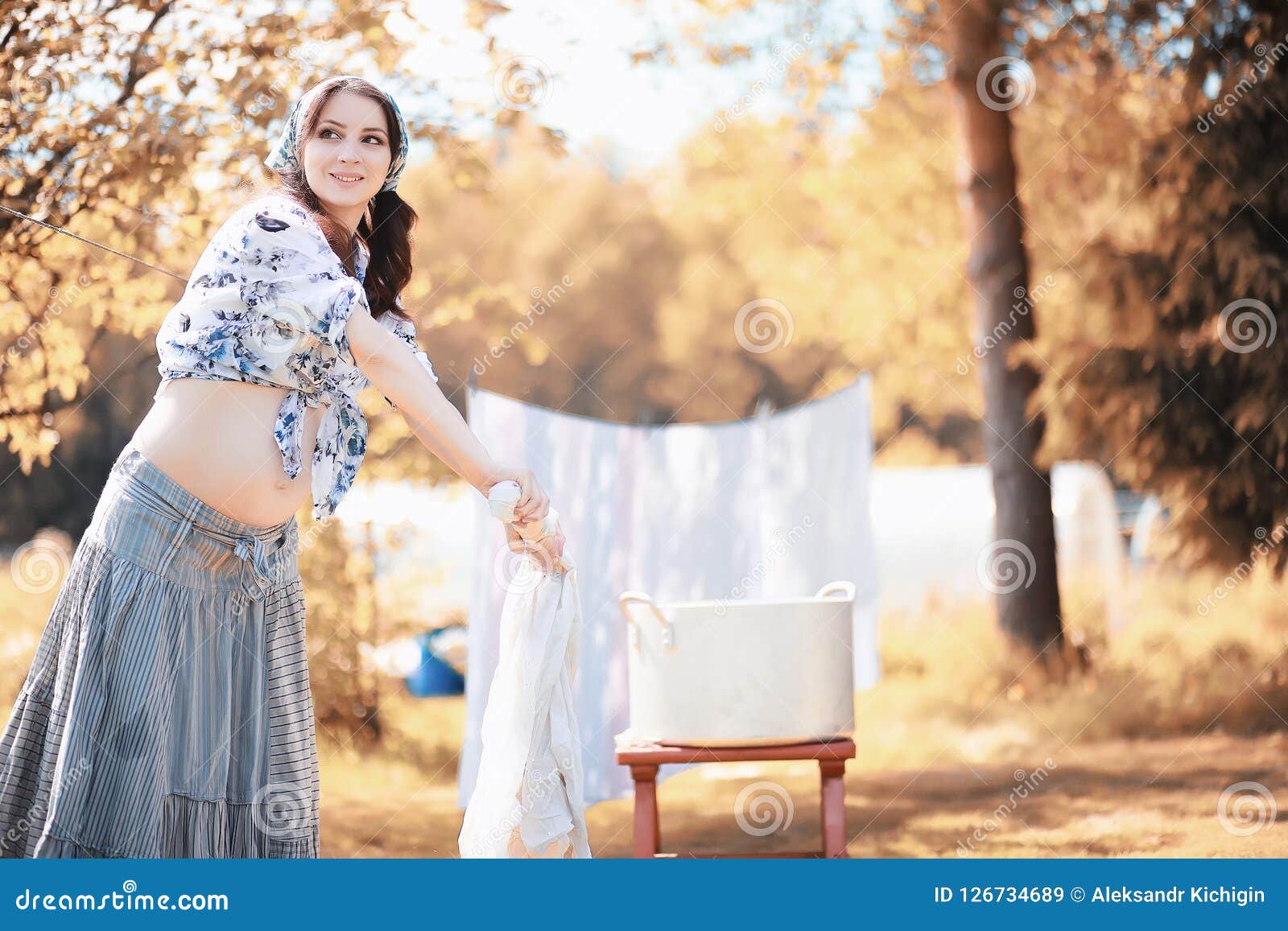 Pregnant Woman Hanging Sheets on the Rope for Drying Stock Image ...